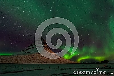 Beautiful Kirkjufell Mountain with Northern Lights Iceland Stock Photo