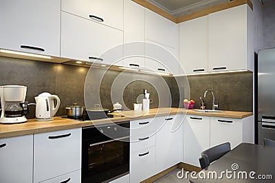 Beautiful kitchen furniture, white painted kitchen with gray tiles Stock Photo