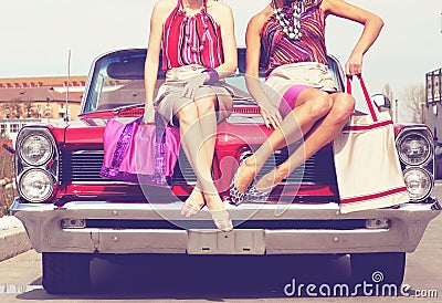 Beautiful ladies legs posing in a vintage retro car Stock Photo