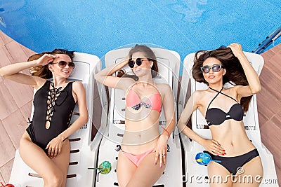 Beautiful ladies spending great time on lounges Stock Photo