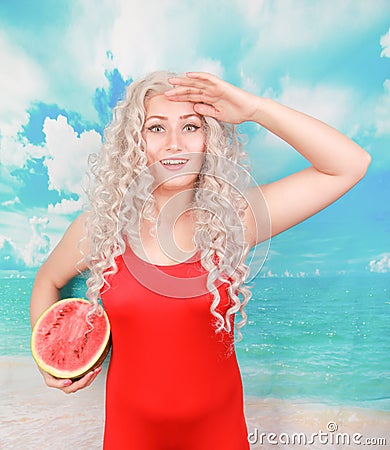 Beautiful young woman with watermelon for eating in summer season at beautiful beach Stock Photo