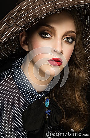 Beautiful Lady in hat over dark background. Retro nostalgic phot Stock Photo