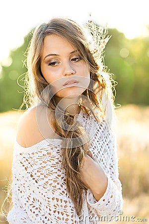 Beautiful lady model in an open field at sunrise Stock Photo
