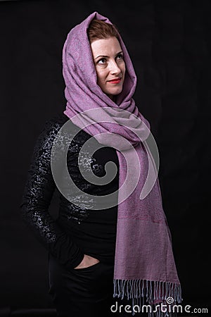 Beautiful lady in neckerchief studio portrait on black background. Stock Photo