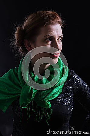 Beautiful lady in neckerchief studio portrait on black background. Stock Photo