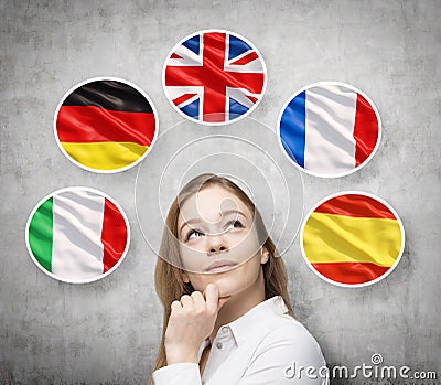 Beautiful lady is surrounded by bubbles with european countries' flags (Italian, German, Great Britain, French, Spanish). Stock Photo