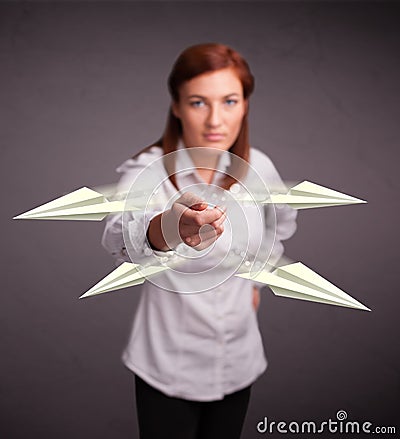 Beautiful lady throwing origami airplanes Stock Photo