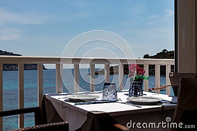 Beautiful laid table in a restaurant overlooking the mediterranean sea in sant elm, mallorca, spain Stock Photo