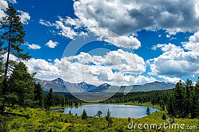 Beautiful lake in the Altai mountains, Siberia, Russia. Wild mountain lake on the background of snowy peaks. Summer landscape Stock Photo