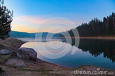 Beautiful lake. Dawn in a mixed forest by the lake Stock Photo