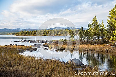 A beautiful lake landscape in Femundsmarka National Park in Norway. Lake with a distant mountains in background. Stock Photo