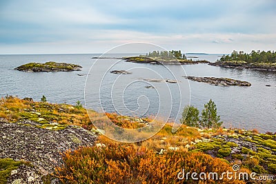 Beautiful Lake Rock Islands Landscape Red Rusty Grass and Green Moss Autumn Scenery Heavy Blue Sky Stock Photo