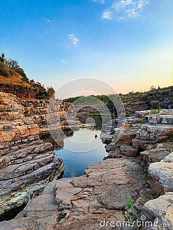 A beautiful lake surrounded by rocky mountain at Chidiya Bhadak, Indore, Madhya Pradesh, India Stock Photo