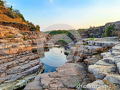 A beautiful lake surrounded by rocky mountain at Chidiya Bhadak, Indore, Madhya Pradesh, India Stock Photo