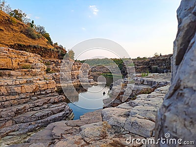 A beautiful lake surrounded by rocky mountain at Chidiya Bhadak, Indore, Madhya Pradesh, India Stock Photo