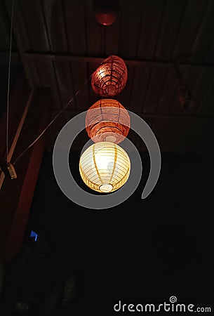Beautiful lamp shades in the night hanging from the ceiling of the roof Stock Photo