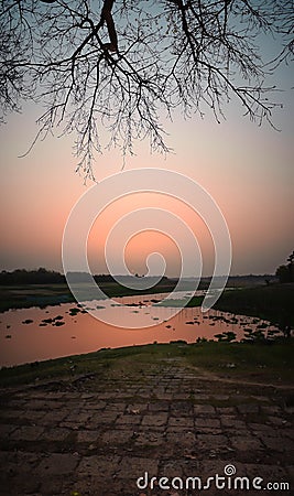 A beautiful landscape at afternoon beside a river bank during golden hours Stock Photo