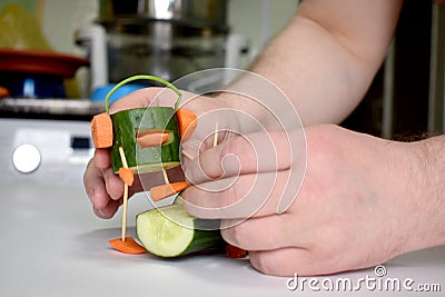 Carving cucumber man athlete music lover Stock Photo