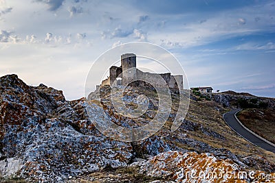Beautiful landscape of Enisala old stronghold citadel with cloudy sky and rocks Stock Photo