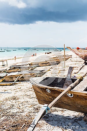 Beautiful landscape with hammock hanging on palm and boats in ocean on the background Stock Photo