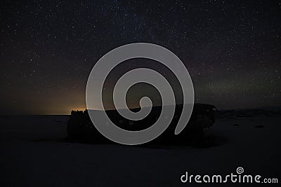 The Northern Lights in Iceland at the plane wreck with a rich green and the Milky Way. Stock Photo