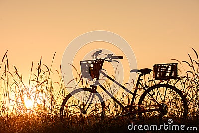 Beautiful landscape image with Silhouette vintage Bicycle at sunset.classic bicycle, for greeting Cards ,post card Stock Photo