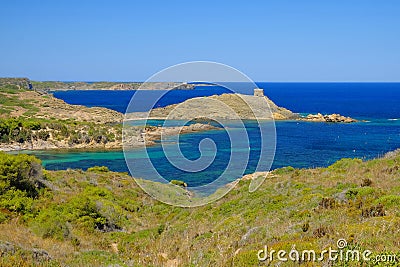 View on the light house Cape Favaritx and the old watch tower Es Colomar in Es Grau on Menorca Stock Photo