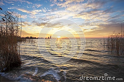 Beautiful landscape with lake, reeds, sunset sky Stock Photo