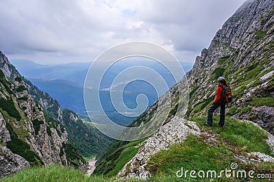 Beautiful landscape in the mountains and woman climber admiring the view Stock Photo