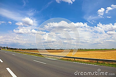 Highway road landscape blue sky white clouds field nature travel asphalt country journey summer empty rural horizon line view trip Stock Photo