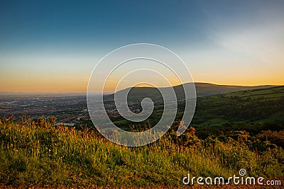 Beautiful landscape over mountains and city at sunset, cave hill belfast, Northern Ireland Stock Photo