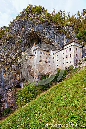 Beautiful landscape photo of Predjama castle Predjamski grad. Renaissance castle built within a cave mouth. Stock Photo