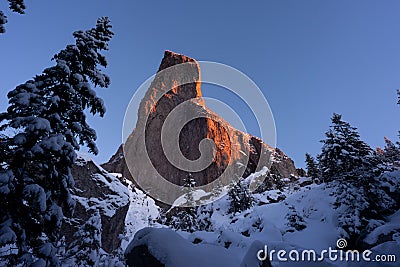 Wall of rock in winter close to Christmas Holiday with pine tree Stock Photo