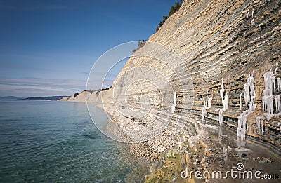 Beautiful landscape sea view. Shore with white pebbles and rocks on a spring day Stock Photo