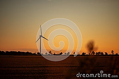 beautiful landscape at sunset. windmill in the field Stock Photo