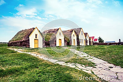 Beautiful landscape with traditional wooden houses with moss-covered roofs and church in Pioneer Museum in Glaumbaer, Iceland. Stock Photo