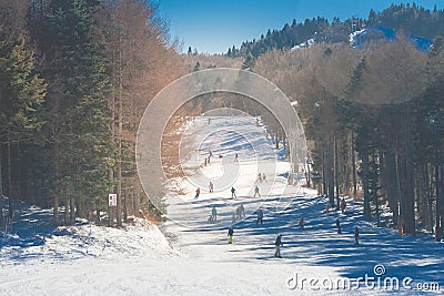 Beautiful landscape view of Mountain covered with white snow and people skiing on white snow at ski resort. Editorial Stock Photo