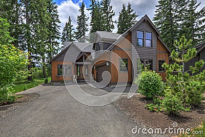 Beautiful large American Northwest home exterior with brown wood in the forest Stock Photo