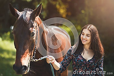 Beautiful Latin woman in dress and her lovely horse walk in the forest. love animals concept. love horses Stock Photo