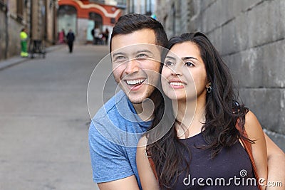Beautiful latino couple smiling while looking away Stock Photo