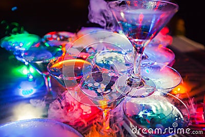 Beautiful line of different colored alcohol cocktails with smoke on a Christmas party, tequila, martini, vodka, and others on part Stock Photo