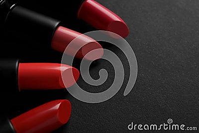 Beautiful lipsticks on black background, closeup. Space for text Stock Photo