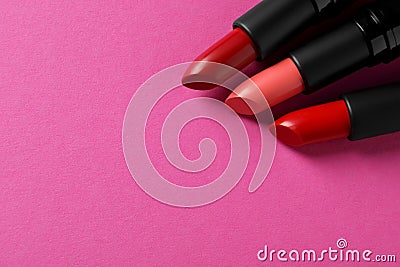 Beautiful lipsticks on pink background, above view. Space for text Stock Photo