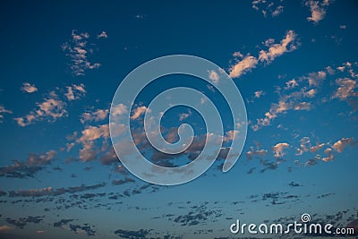 Beautiful little clouds illuminated by the sunset sun. Golden Hour Resource for designers Stock Photo