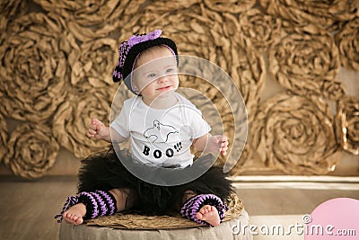 beautiful little girl with Down syndrome in a suit a little witch Stock Photo