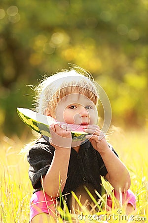 Beautiful little girl eating watermelon on the nature Stock Photo