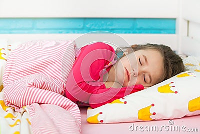 Beautiful little girl in pajamas sleep in bed under blanket Stock Photo