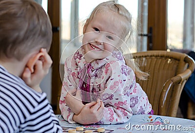 Beautiful little girl playing a game of checkers Stock Photo