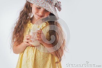 Beautiful little girl eating tasty cream dessert portrait isolated on white background Stock Photo