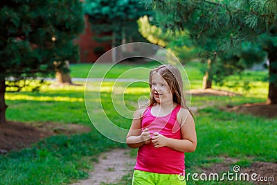 Beautiful little girl on the street through Stock Photo